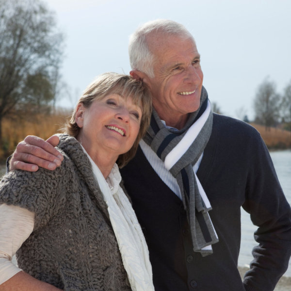Senior couple walking by lake